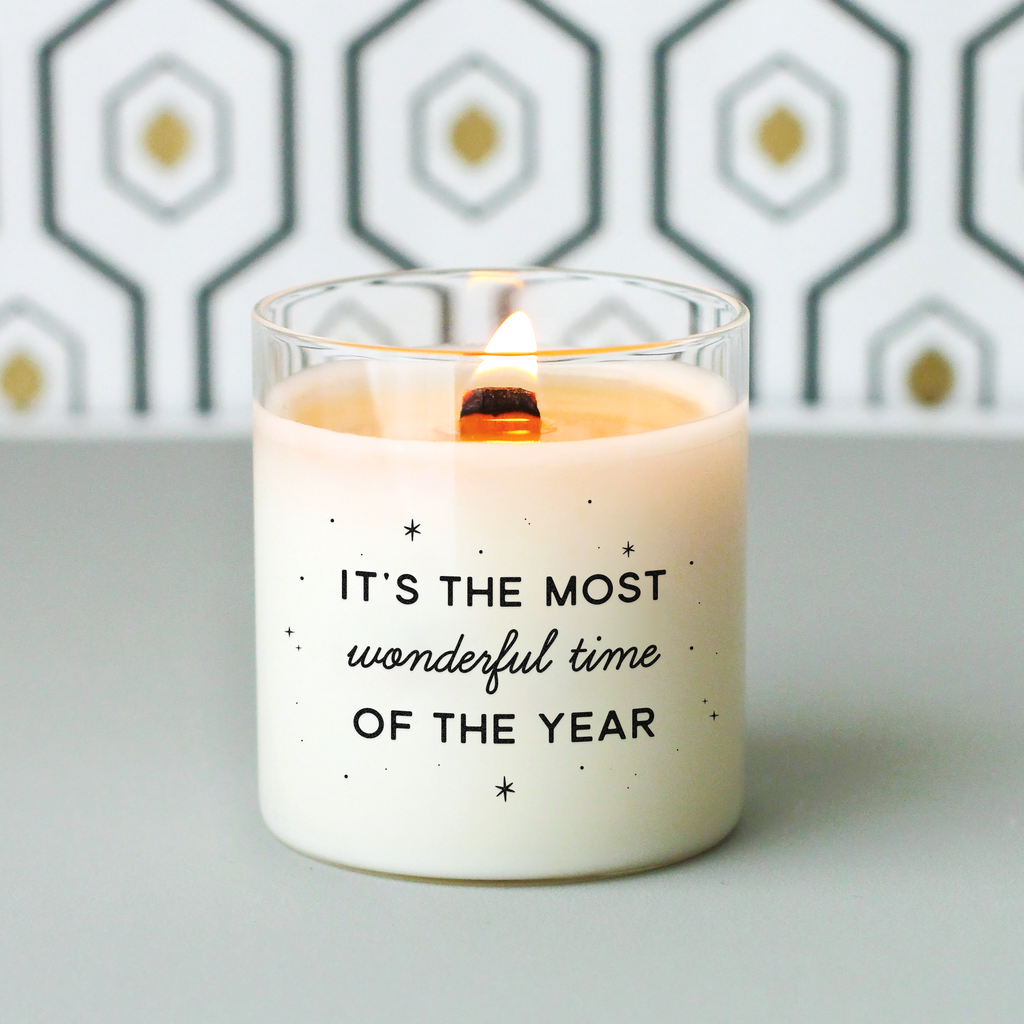 Bougie blanche avec l’inscription « It’s the most wonderful time of the year » entourée de petites étoiles noires. Idéale pour créer une ambiance de Noël festive et chaleureuse.