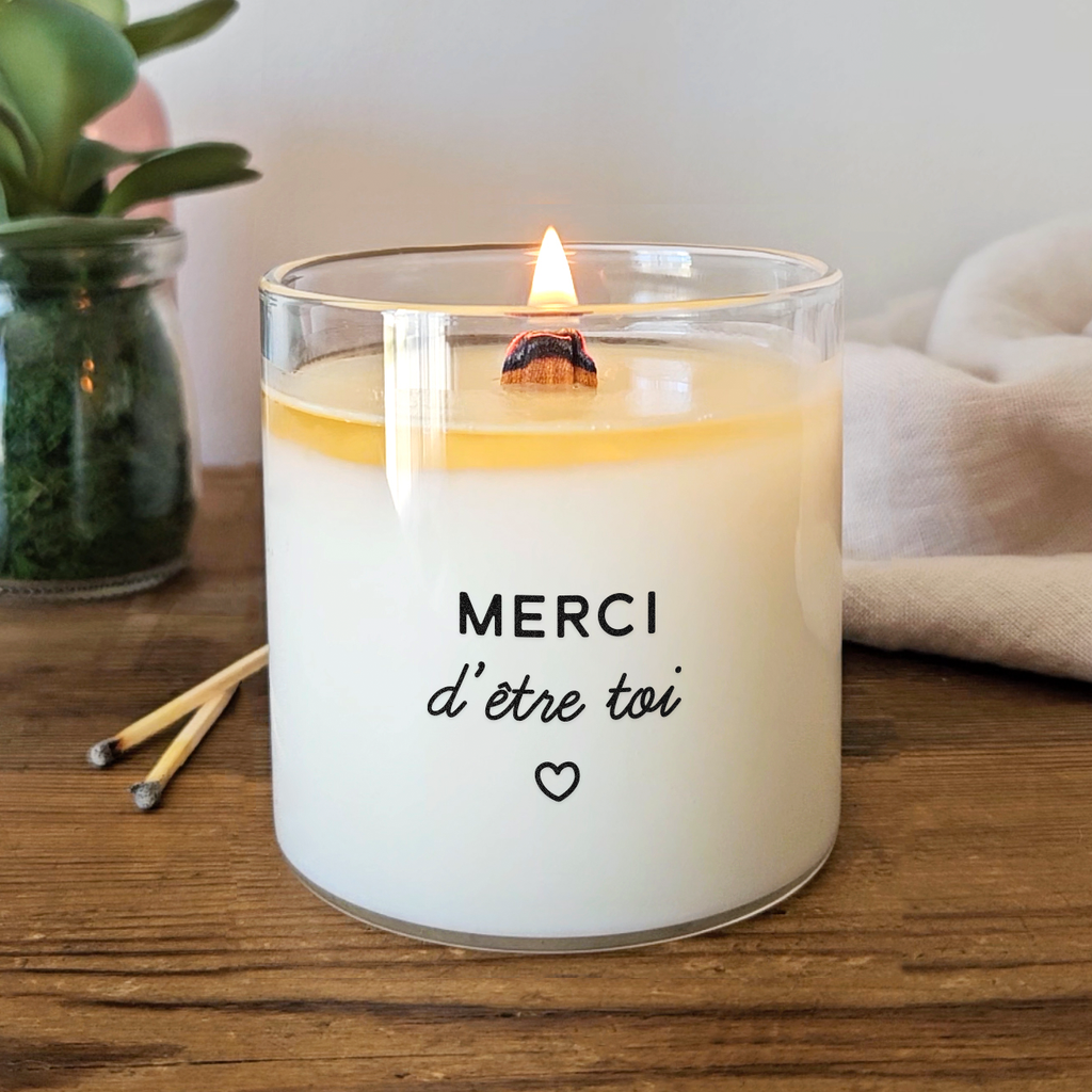 Bougie à message « Merci d’être toi » avec un petit cœur, imprimée sur cire blanche dans un contenant en verre transparent. Idée cadeau tendre et personnalisée pour dire merci à une personne chère.