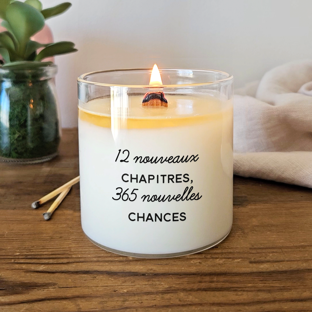 Bougie blanche avec le texte « 12 nouveaux chapitres, 365 nouvelles chances » imprimé en noir. Parfaite pour célébrer le Nouvel An avec style et intention.